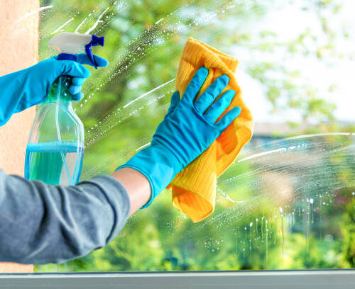 Cleaning window pane with detergent, spring cleaning concept Cleaning window pane with detergent, spring cleaning concept